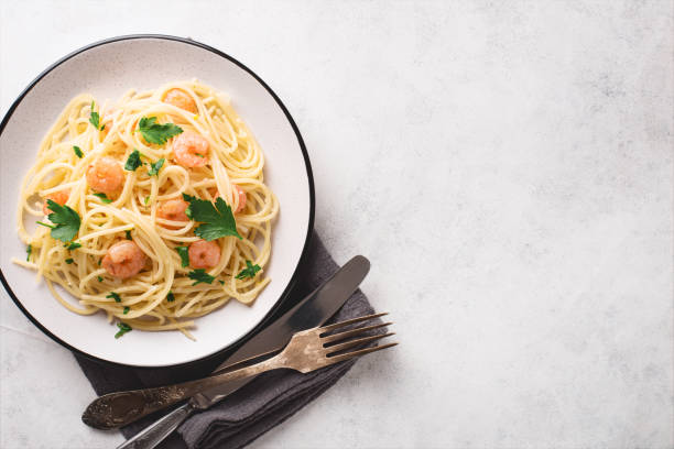 istock Spaghetti shrimp scampi in a plate with free space for text 1305769498