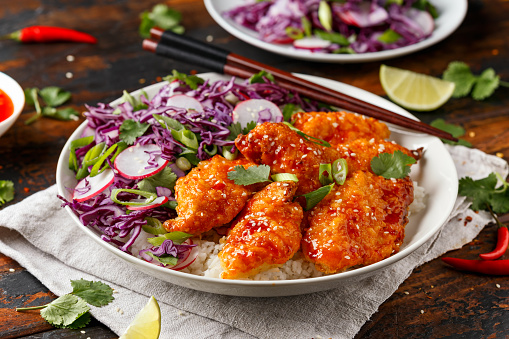 Korean Fried chicken with red cabbage salad and white rice. Asian food.