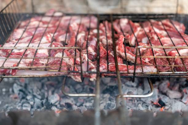 istock Lamb ribs cooked over an open fire, close-up. Lamb chops Grilling Barbecue, BBQ Originally made from lamb. Wire rack for roast lamb in the grill racks. The concept of traditional food on fire 1305770170