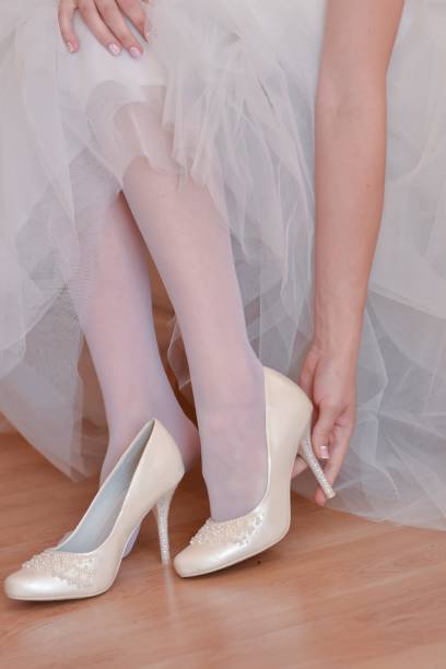 istock The bride puts on her wedding shoes 1305771577