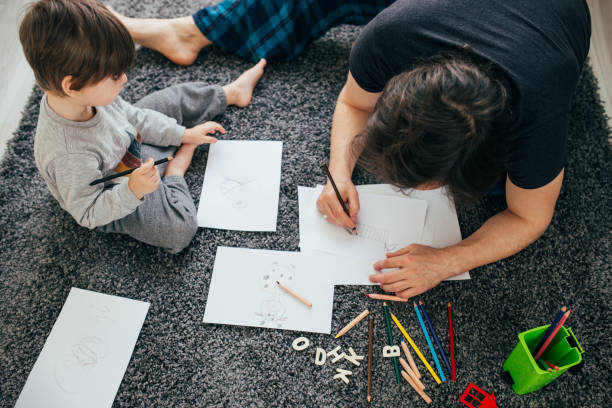 istock Dad and little toddler son draw with colored pencils 1305775876