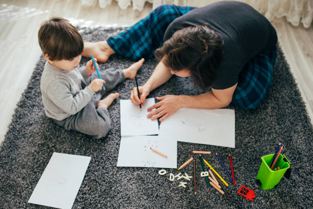 istock Dad and little toddler son draw with colored pencils 1305776464