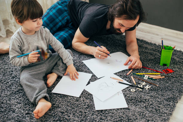 istock Dad and little toddler son draw with colored pencils 1305776664