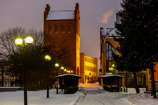 The Upper Gate in Olsztyn, also known as the High Gate - the city gate in Olsztyn, existing since the 14th century. Winter evening.