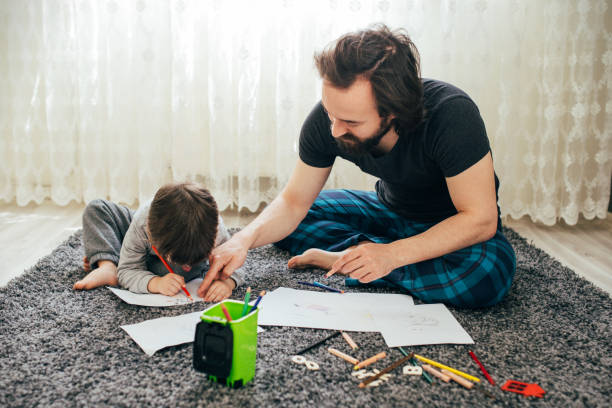 istock Dad and little toddler son draw with colored pencils 1305777872