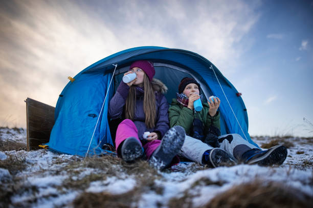 istock Kids enjoying camping in tent on the hill 1305778394