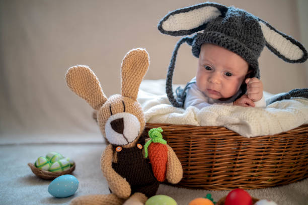 istock Cute baby bunny in the basket 1305781805
