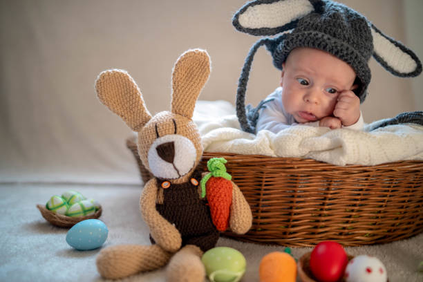 istock Cute baby bunny in the basket 1305781856