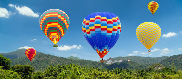 istock Hot air balloons landing in a mountain 1305782042