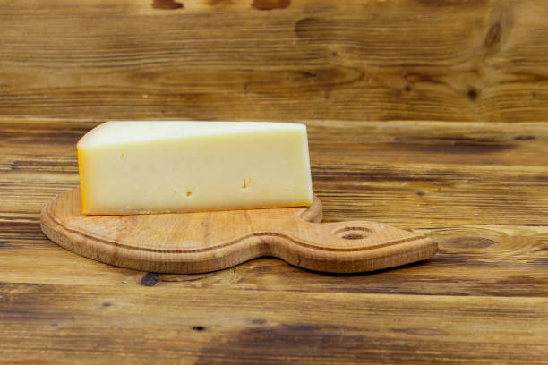 istock Piece of cheese on a wooden table 1305783661