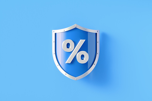 Silver shield with percentage sign sitting on blue background, Horizontal composition with copy space. Efficiency and safety concept.
