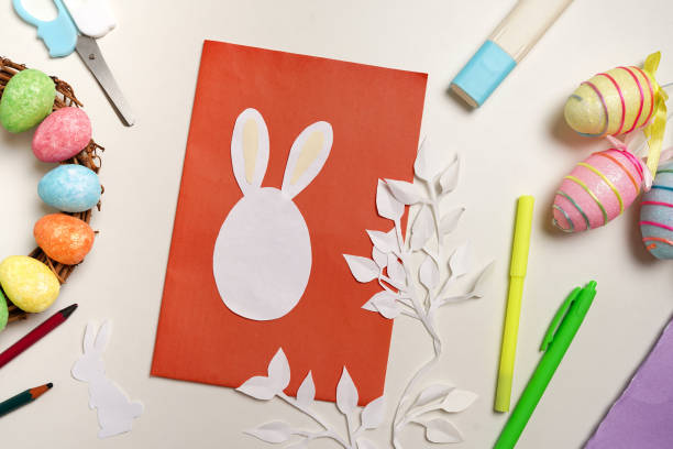 istock Diy Easter cards from paper. Volume greeting card with a bunny, on white background. Gift idea, decor Spring, Easter. 1305787616