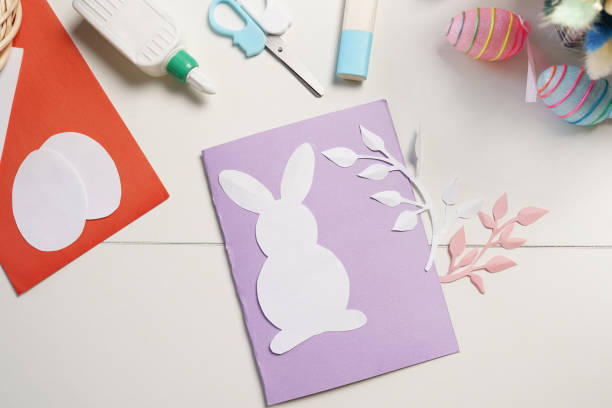 istock Diy Easter cards from paper. Volume greeting card with a bunny, on white background. Gift idea, decor Spring, Easter. 1305788263