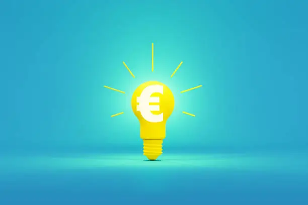 Photo of Business Idea Concept - Light Bulb With White Euro Symbol Sitting On Blue Background