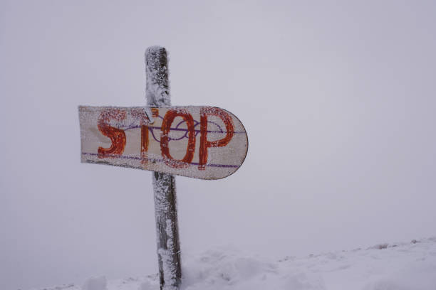 istock Snow-covered warning sign with the inscription 