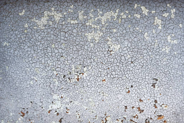 istock Cracked texture. Old paint on the wall. Structural gray background of old paint. 1305789586
