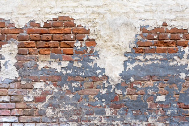 istock Grunge empty red stonewall background. Old brick wall texture. Painted distressed wall surface. Weathered building facade with old damaged plaster. Grungy brickwall. 1305789608