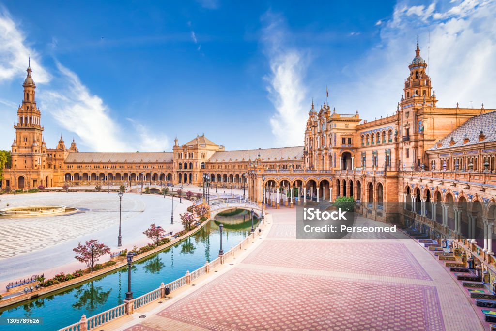 Spain Square in Seville, Spain. A great example of Iberian Renaissance architecture during a summer day with blue sky Spain, Seville. Spain Square, a landmark example of the Renaissance Revival style in Spanish architecture Seville Stock Photo