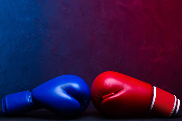istock Boxing gloves Red and Blue hitting together poster design. 1305790759