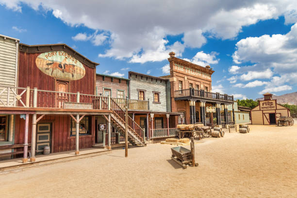 Vintage Far West town with saloon. Old wooden architecture in Wild West. ALMERIA, SPAIN - CIRCA AUGUST 2020: Vintage Far West town with saloon. Old wooden architecture in Wild West with blue sky background. saloon photos stock pictures, royalty-free photos & images