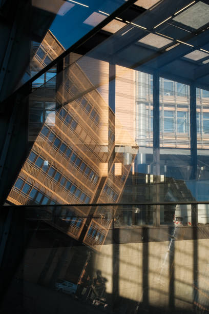 istock Office building reflected in glass facade. 1305791127