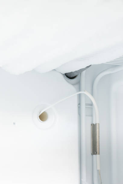 domestic fridge freezer defrost problem concept. refrigerator covered with ice. appliance repair concept - defreeze imagens e fotografias de stock