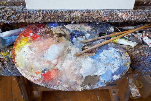 Artist's palette and primed canvas in the studio