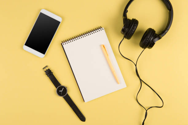 istock Smartphone, notepad, headphones, pen and watch 1305798537