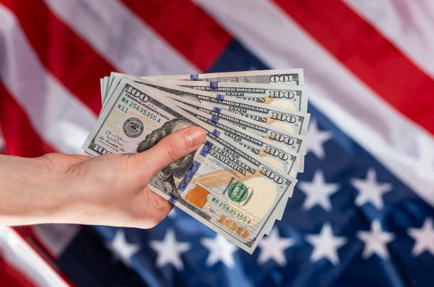 istock American dollars bank notes in female hands 1305800403