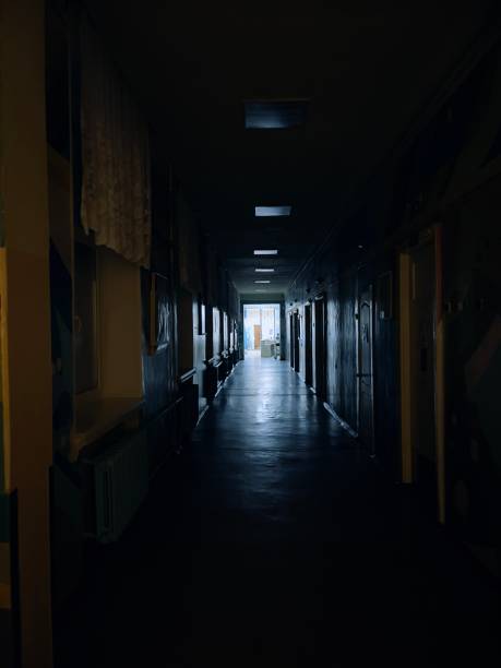 istock dark scary corridor and light at the end 1305802702