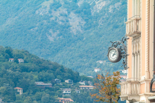 A clock on a building in Como on Lake Como in Lombardy, Italy. The building may be privately owned.