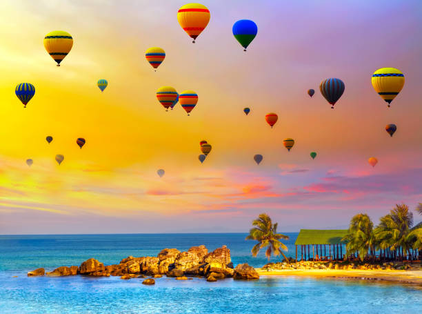 Colorful hot air balloons flying tropical island. Ballooning panoramic nature landscape tropical beach palm trees turquoise ocean of summer sky
