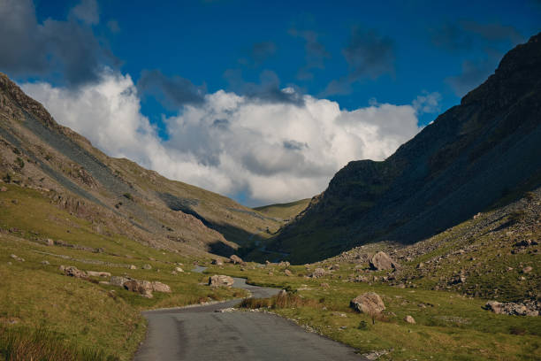 The landscape of countryside road though mountain range in Lake District National Park, Cumbria, United Kingdom