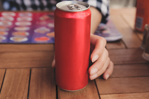 Woman holding aluminum can