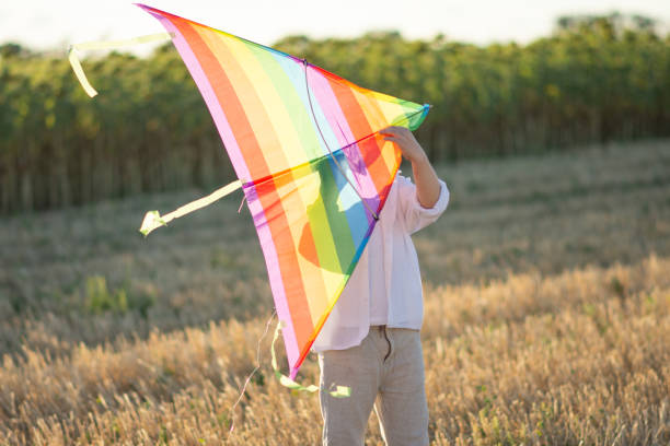 istock child preparing the kite to go fly 1305807238