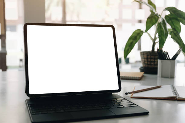 istock Mock up Blank screen computer desktop with keyboard in cafe or co-working background. 1305808678