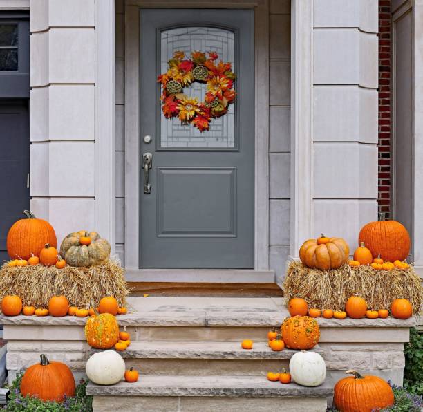 Front steps of house with pumpkins and fall decorations Front steps of house with pumpkins and fall decorations doorstep stock pictures, royalty-free photos & images