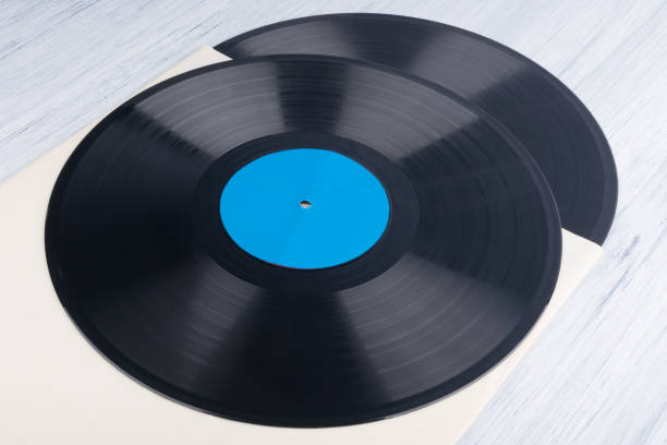 istock on a light gray background, on a paper envelope, are two vinyl records, background 1305811278