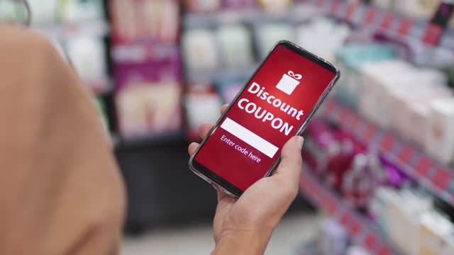 Woman Holding Smartphone With Discount Coupon