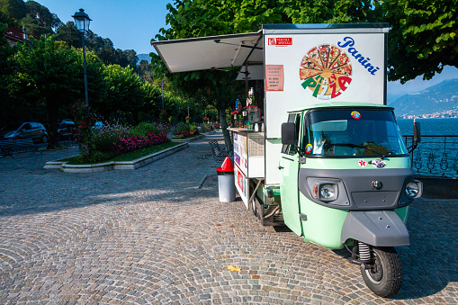 Piaggio Food Truck in Bellagio on Lake Como, Italy, with a pizza image visible as well as stickers