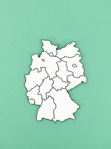 Hand-cut silhouette of Germany with its 16 constituent states borders drawn on paper shape