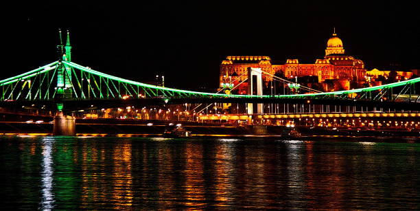 Chain bridge on Danube river and Buda Castle building at night, Budapest, Hungary. Chain bridge and Buda Castle building as seen from Danube river  at night, Budapest, Hungary. budapest danube river cruise hungary stock pictures, royalty-free photos & images