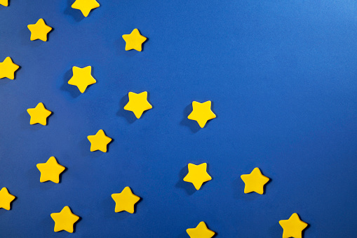 Stars made with play clay on blue background with copy space