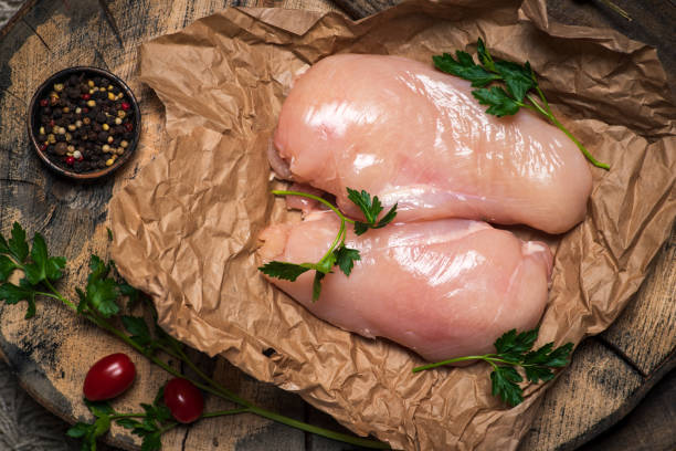 istock Raw uncooked chicken breast with cooking ingredients 1305817637