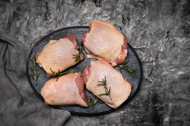 istock Raw chicken thighs meat with cooking ingredients 1305817760
