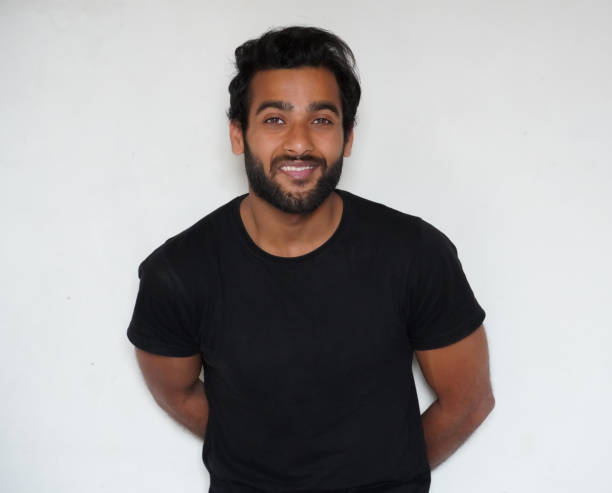 istock A shy man watching in camera and giving smile portrait 1305817778