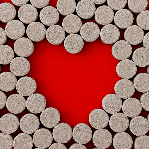 istock close-up of DGL (licorice root extract) chewable tablets. dietary concept: pills around a central empty space in the form of a heart. dietary supplement topview 1305817787