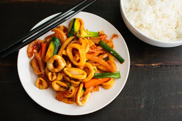 A Korean seafood dish made with squid and vegetables stir-fried in a sweet and spicy sauce