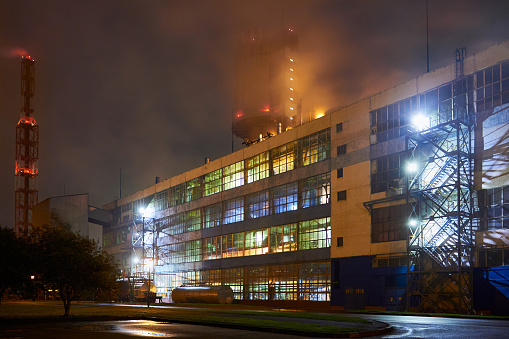 Petrochemical plant in night. Urea Granulation Tower fertilizer granulator prilling, high-tower complex. Long exposure photography.