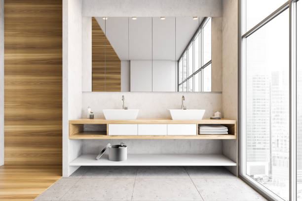 istock Wooden and white bathroom with two sinks, mirror and big window 1305820173